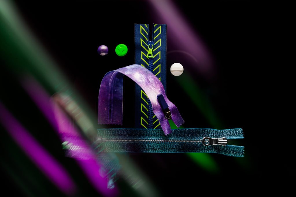 A creative display of colorful zippers with unique designs against a dark background
