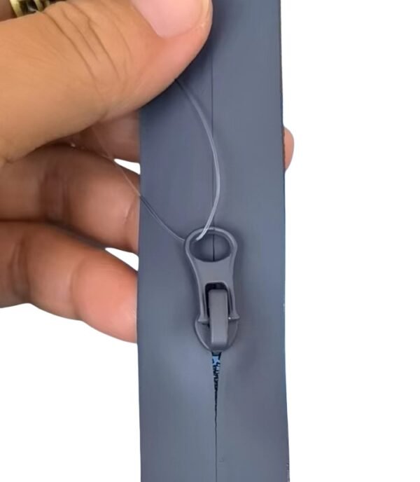 Close - up of a grey waterproof zipper slider and its mechanism