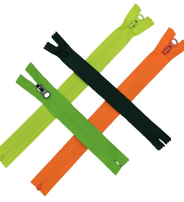 Four crossed zippers in lime green, dark green, orange and black