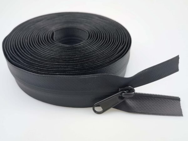 A roll of black waterproof zipper with a black zipper pull, displayed on a white background.